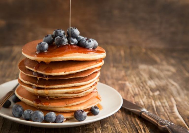 Berry pancakes stack with maple syrup